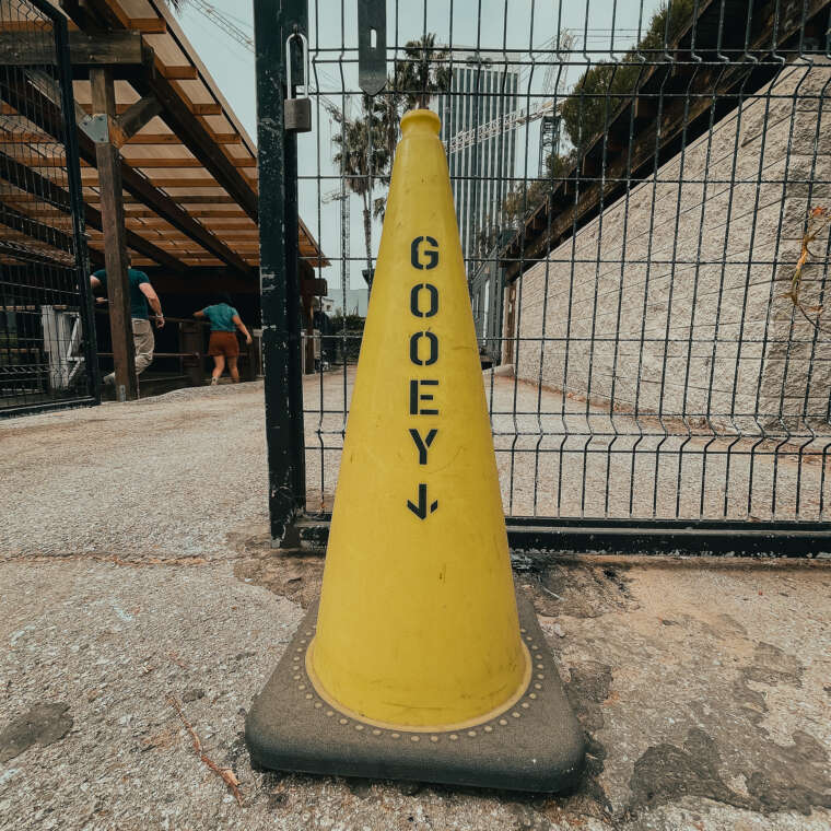 yellow traffic cone with text "gooey" and and arrow pointing down